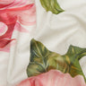A close-up of Liberty Fabrics featuring a watercolor floral print with pink roses and green leaves on a white background, with the brand logo in the bottom right corner.