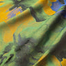 Close-up of a textured fabric with green, yellow, and blue colors.