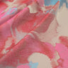 Close-up of fabric with pink, blue, and beige abstract pattern