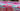 A colourful floral patterned fabric with pink, red and blue set out on a store table.