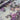 Floral fabric with purple and grey flowers on a light blue background