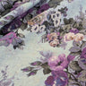 Floral fabric with purple and grey flowers on a light blue background