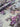 Floral fabric with purple and grey flowers on a light blue background