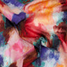 A close-up of draped Liberty Fabrics featuring a vibrant, painterly abstract pattern with blended shades of red, pink, purple, teal, orange, and white.