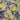 A linen fabric featuring a floral pattern with shades of blue, yellow, and grey, giving an impressionist garden look.