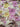 A close up of a linen fabric featuring a floral print with soft colours like pink and yellow
