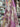 Floral fabric with pink and yellow flowers shown draped within a store setting