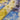 Close-up of floral fabric with blue, yellow, and purple flowers.
