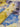 Close-up of floral fabric with blue, yellow, and purple flowers.