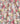 A close-up of a pleated fabric with an all-over multicolor floral print, featuring pink, yellow, white, and red flowers on a dark background. A 'UBERTY' brand watermark is visible in the bottom right corner.