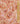 A close-up of a paisley fabric pattern in pink, orange, and brown.