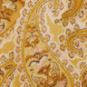 A close-up of a Liberty Fabrics fabric pattern featuring a warm yellow and beige paisley design with brown and pink accents.