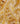 A close-up of a Liberty Fabrics fabric pattern featuring a warm yellow and beige paisley design with brown and pink accents.