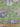 Fabric with nautical pattern featuring shells and ropes on a green background, with a ruler at the bottom for scale.