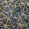 Close-up of a printed pure cotton batiste, with a geometric motif in cobalt blue, ivory, and black, with interlocking circles and angular lines.