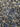 Close-up of a printed pure cotton batiste, with a geometric motif in cobalt blue, ivory, and black, with interlocking circles and angular lines.