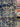 Close-up of a printed pure cotton batiste, with a geometric motif in cobalt blue, ivory, and black, with interlocking circles and angular lines, showing the transparency and lightness of the fabric.