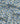 Light blue fabric with an all-over daisy print, featuring white petals, yellow centers, and green stems. A watermark for 'LIBERTY FABRICS' is visible in the bottom right corner.