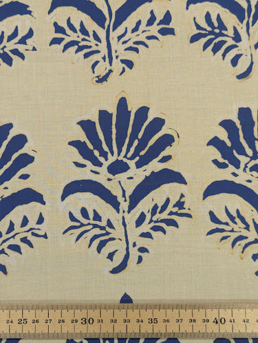 Printed pure cotton fabric with blue floral motifs on an ivory background, featuring a ruler at the bottom for scale.