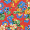 A close-up of Liberty Fabrics floral pattern featuring blue, yellow, and purple flowers with green leaves on a bright red background.