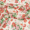 A close-up of draped fabric featuring a watercolor-style floral print with red, pink, and coral flowers and green leaves on a warm cream background. A 'LIBERTY FABRICS' watermark is visible in the bottom right corner.