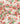 A close-up of draped fabric featuring a watercolor-style floral print with red, pink, and coral flowers and green leaves on a warm cream background. A 'LIBERTY FABRICS' watermark is visible in the bottom right corner.