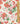 A close-up of a floral fabric pattern featuring pink, coral, and red flowers with green leaves on a cream background, with a wooden ruler on the right side and a Liberty Fabrics logo in the bottom right corner.