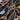 Close-up of a pure wool printed fabric with a horse bridle design on a dark brown background