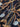 Close-up of a pure wool printed fabric with a horse bridle design on a dark brown background