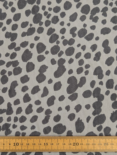 Grey leopard pattern printed on 100% wool fabric shown with a ruler at the bottom for scale