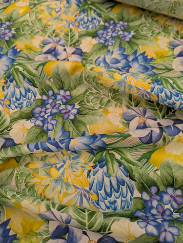 Colorful floral fabric with blue, yellow, and green flowers.