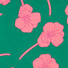 A close-up of Liberty Fabrics floral pattern featuring pink flowers and stems on a vibrant green background.