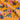 Floral patterned fabric with pink and blue flowers on a orange background