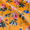 Floral patterned fabric with pink and blue flowers on a orange background