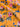 Floral patterned fabric with pink and blue flowers on a orange background