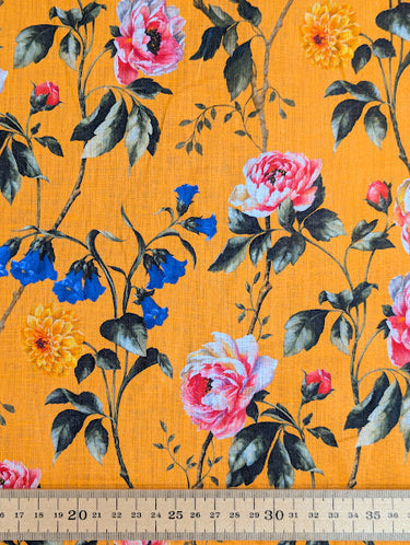 Floral fabric pattern with an orange background, and a ruler shown at the bottom for scale.