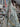 Floral fabric swatch held up against a blurred fabric store background