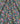 A close-up of a dark navy floral fabric with a dense, multicolored print of flowers and green leaves.
