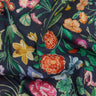 A close-up of Liberty Fabrics floral print fabric with a dark navy background and colorful flowers including pink, orange, yellow, and blue blossoms with green leaves.