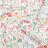 A close-up of a lightweight fabric with a delicate, multi-colored floral print on a warm cream background. The pattern features pink, red, purple, and blue flowers with green leaves.
