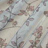 Close-up view of shimmer printed chiffon fabric with floral patterns.