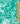 A close-up of a turquoise and white floral patterned fabric with a wooden ruler on the right side for scale, and a 'Liberty Fabrics' logo in the bottom right corner.