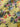 Close up of floral patterned fabric with colourful flowers and leaves on a yellow background