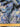 Pure wool fabric with blue and lavender abstract flowers shown with a ruler at the bottom for scale