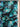 Pure wool fabric with artistic painterly florals in green, black and blue  featuring 'Emanuel Ungaro' on the selvedge.