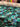 Roll of pure wool fabric featuring abstract painterly florals in green, black and blue.