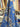 Blue fabric with floral pattern shown in a store setting