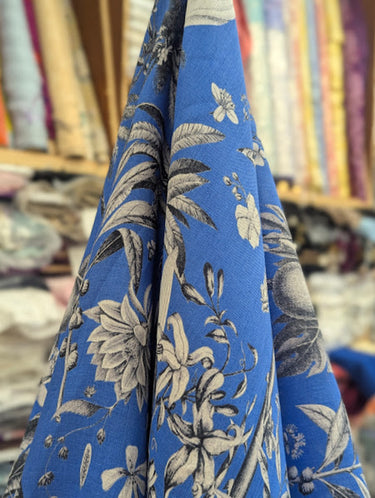 Blue fabric with floral pattern shown in a store setting