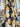 Photo of a printed pure wool fabric featuring yellow flowers on a navy background, draped within a shop setting.
