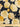 Close-up of a printed pure wool fabric featuring yellow florals on a navy background, with a ruler at the bottom for scale.